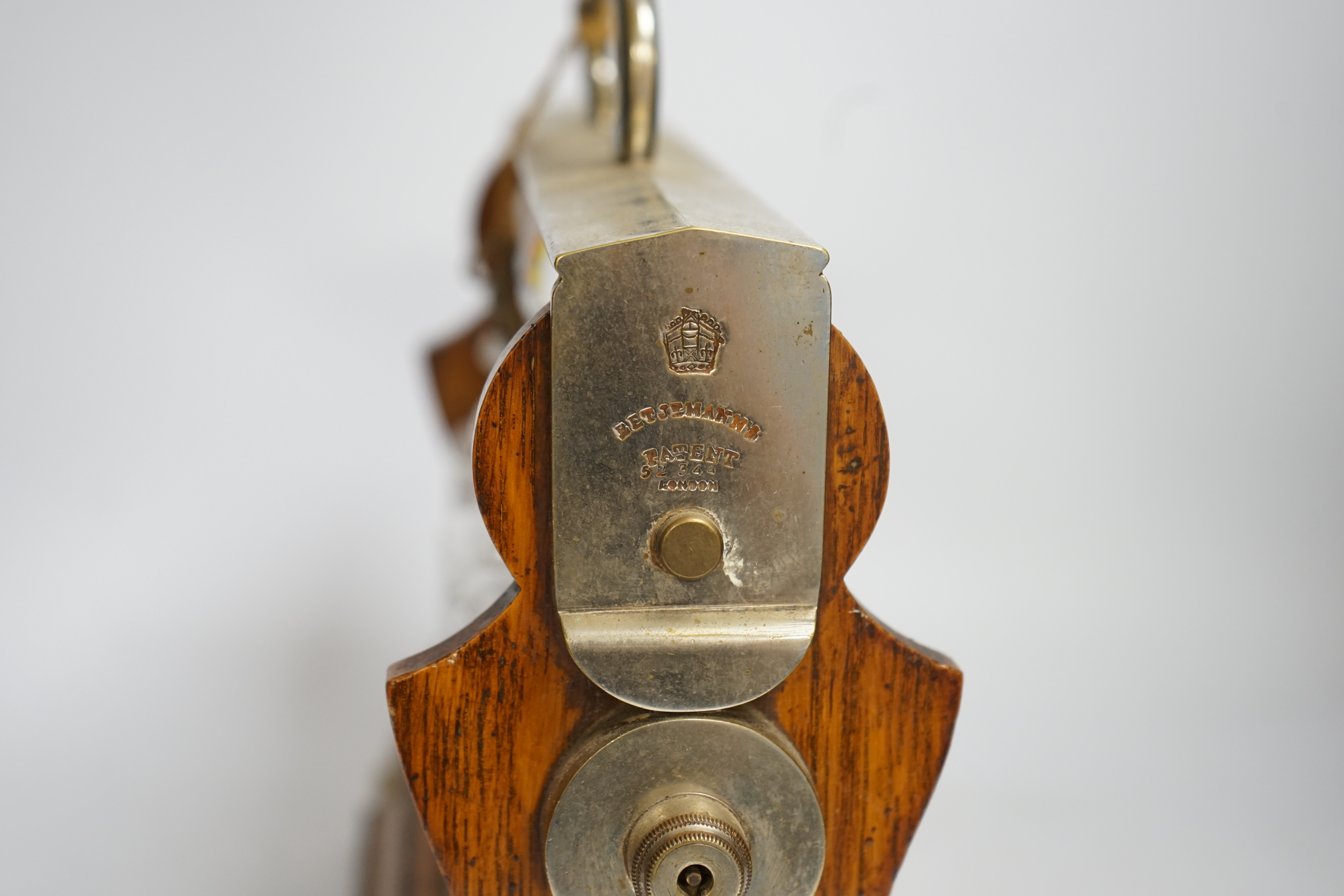 A Betjemann’s patent oak three bottle tantalus with key, 32cm wide